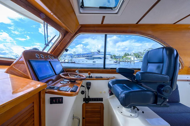 Gotcha Covered Yacht Photos Pics Interior helm of 2006 Hinckley Talaria 40 yacht with leather captain's chair and navigation controls.