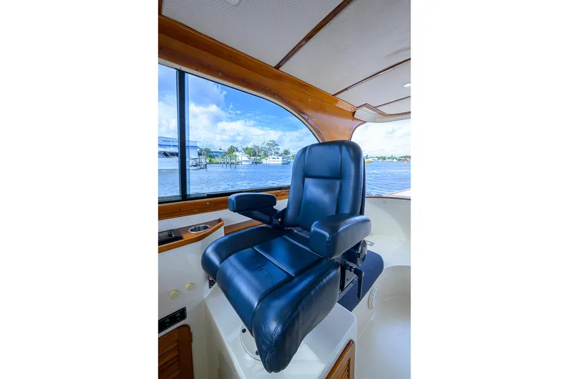 Gotcha Covered Yacht Photos Pics Captain's chair on 2006 Hinckley Talaria 40 yacht, overlooking scenic waterfront.