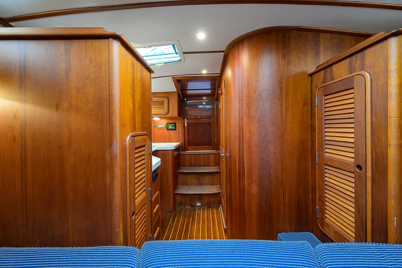 Gotcha Covered Yacht Photos Pics Interior of 2006 Hinckley Talaria 40 yacht with wooden cabinetry and blue seating.