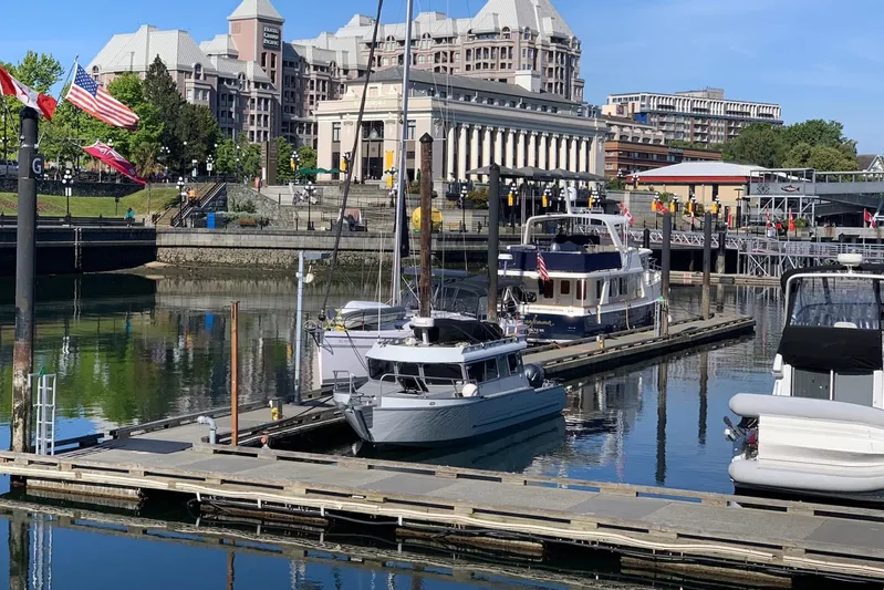  Yacht Photos Pics 2015 River Hawk SH Offshore XL docked in scenic marina with historic buildings.