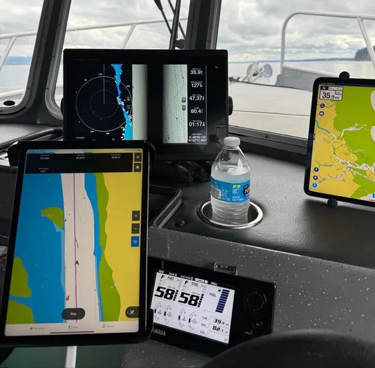  Yacht Photos Pics 2015 River Hawk SH Offshore XL dashboard with navigation screens and a water bottle.