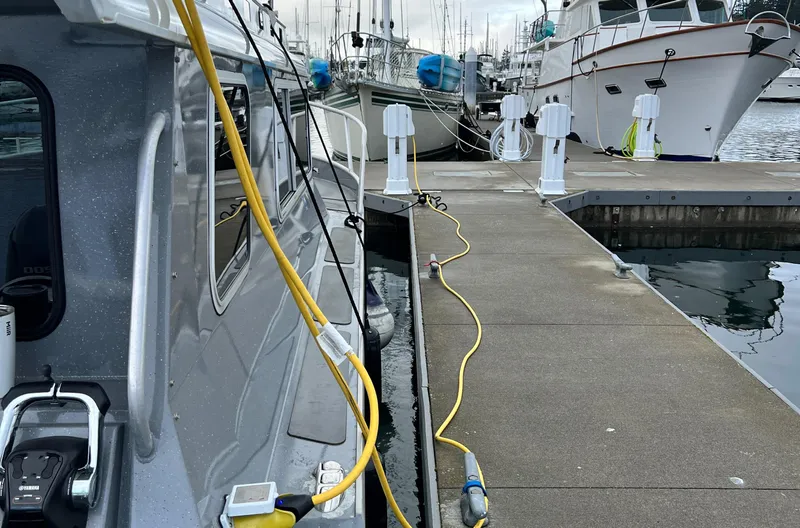  Yacht Photos Pics 2015 River Hawk SH Offshore XL docked at marina with power cables connected.