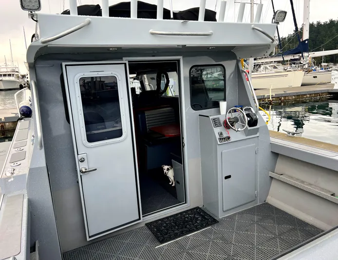  Yacht Photos Pics 2015 River Hawk SH Offshore XL boat docked, rear view with open cabin door.