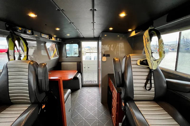  Yacht Photos Pics Interior of a 2015 River Hawk SH Offshore XL boat with seating and table.