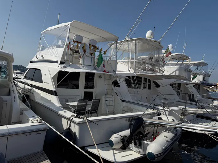  Yacht Photos Pics 1991 Bertram 43 Convertible yacht docked at marina, surrounded by other boats.