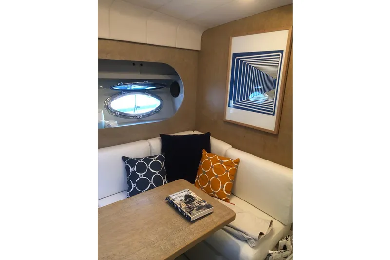  Yacht Photos Pics Cozy interior of 1992 Riva TROPICANA 43 yacht with stylish cushions and modern artwork.
