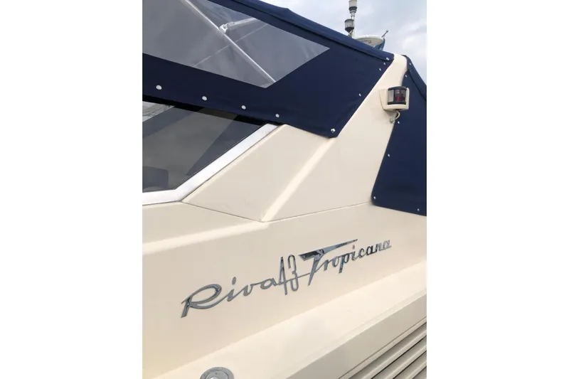  Yacht Photos Pics 1992 Riva TROPICANA 43 boat with blue canopy and elegant design.