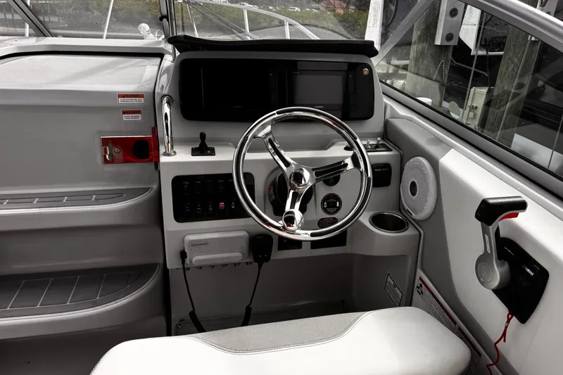  Yacht Photos Pics 2021 Regal 26 XO boat helm with steering wheel and control panel.