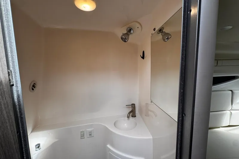  Yacht Photos Pics 2021 Regal 26 XO boat bathroom with sink, mirror, and lighting.