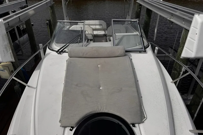  Yacht Photos Pics 2021 Regal 26 XO boat with open deck and seating, docked by the water.