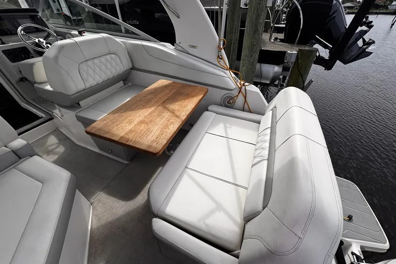  Yacht Photos Pics 2021 Regal 26 XO boat interior with white seating and wooden table.