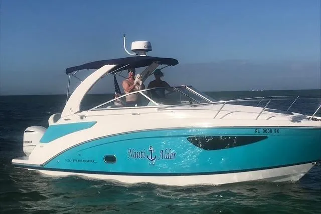  Yacht Photos Pics 2021 Regal 26 XO boat on water, featuring blue and white design.