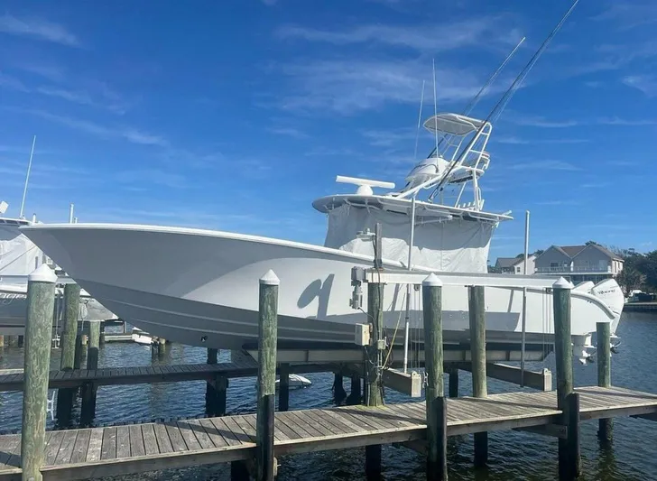  Yacht Photos Pics 2023 Yellowfin 39 Offshore boat docked at a marina under a clear blue sky.
