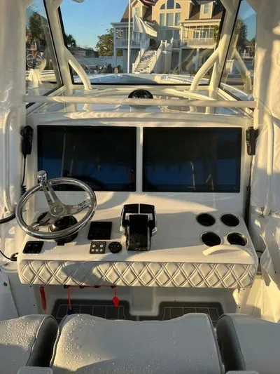  Yacht Photos Pics 2023 Yellowfin 39 Offshore boat cockpit with dual screens and steering wheel.