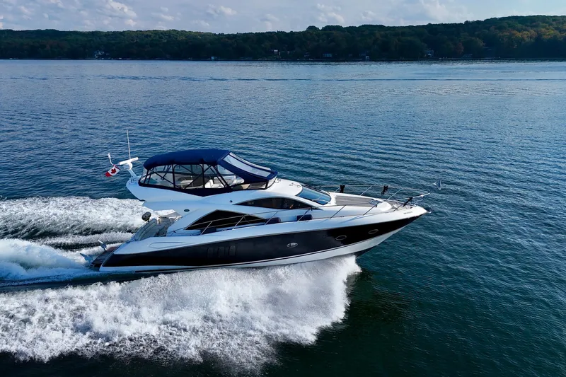 Why Not Yacht Photos Pics 2005 Sunseeker Manhattan 50 yacht cruising on a serene lake.