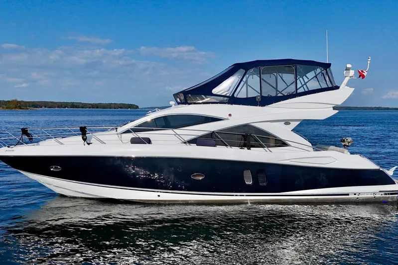 Why Not Yacht Photos Pics 2005 Sunseeker Manhattan 50 yacht cruising on a calm blue sea under a clear sky.