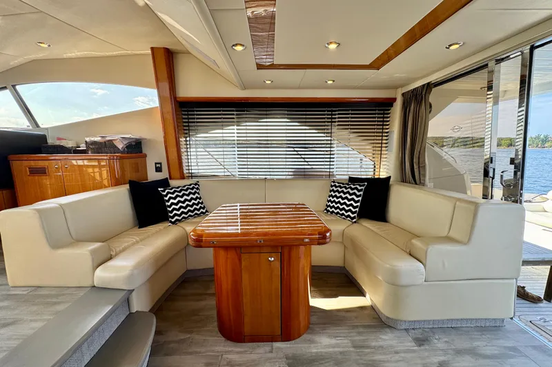 Why Not Yacht Photos Pics Luxurious interior of 2005 Sunseeker Manhattan 50 yacht with elegant seating and wooden table.