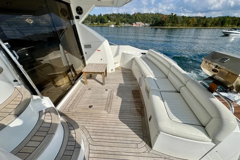 Why Not Yacht Photos Pics 2005 Sunseeker Manhattan 50 yacht deck with seating, table, and scenic water view.