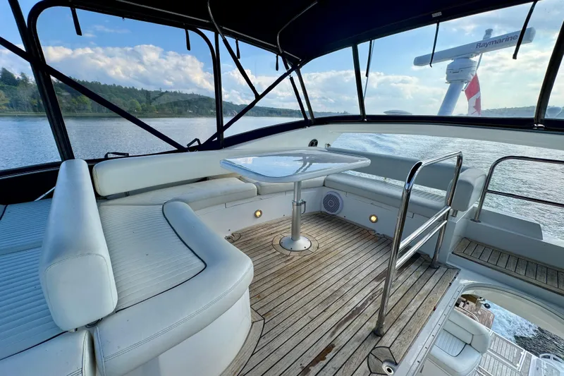 Why Not Yacht Photos Pics Luxurious 2005 Sunseeker Manhattan 50 yacht interior with elegant seating and scenic water view.