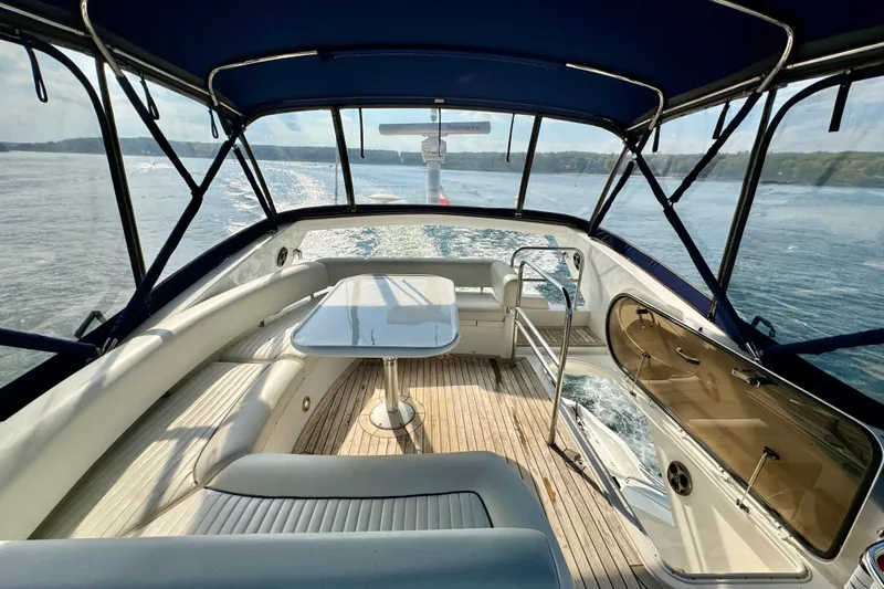 Why Not Yacht Photos Pics Luxurious 2005 Sunseeker Manhattan 50 yacht interior with elegant seating and scenic ocean view.