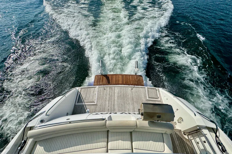 Why Not Yacht Photos Pics Rear view of 2005 Sunseeker Manhattan 50 yacht cruising on open water.