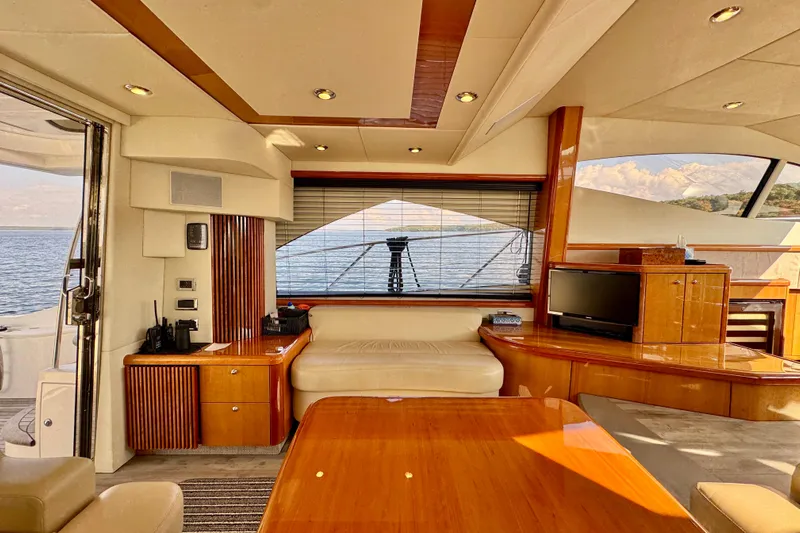 Why Not Yacht Photos Pics Luxurious interior of 2005 Sunseeker Manhattan 50 yacht with elegant wood finishes and ocean view.