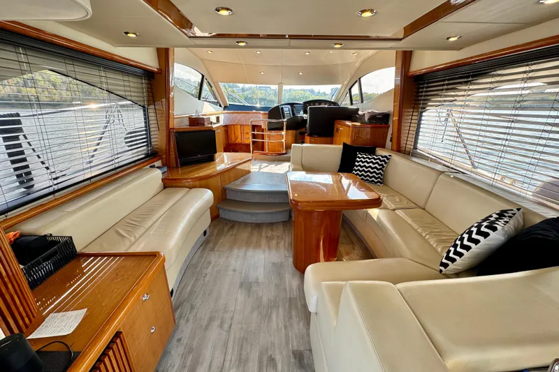Why Not Yacht Photos Pics Luxurious interior of 2005 Sunseeker Manhattan 50 yacht with elegant seating and wooden accents.