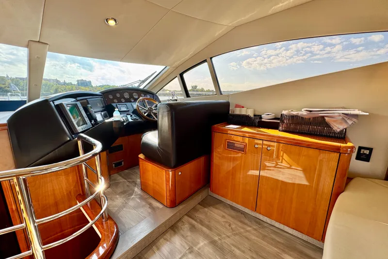 Why Not Yacht Photos Pics Luxurious 2005 Sunseeker Manhattan 50 yacht interior with sleek helm and wooden cabinetry.