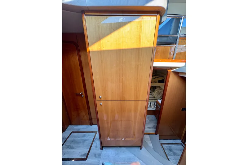 Why Not Yacht Photos Pics Interior of 2005 Sunseeker Manhattan 50 yacht, featuring wooden cabinetry and modern design.