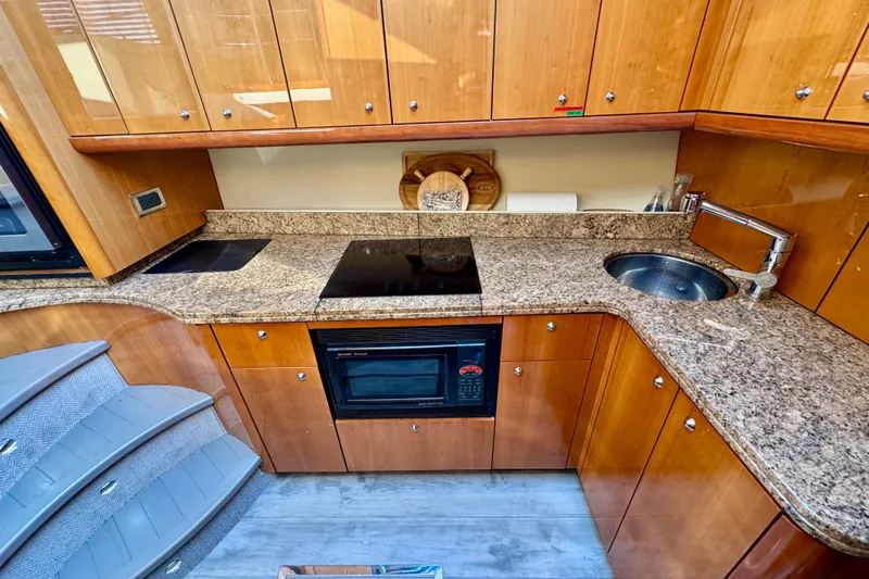 Why Not Yacht Photos Pics Luxurious 2005 Sunseeker Manhattan 50 yacht kitchen with granite countertops and modern appliances.