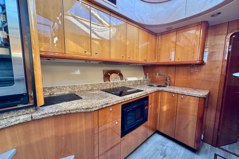 Why Not Yacht Photos Pics Luxurious kitchen interior of 2005 Sunseeker Manhattan 50 yacht with wooden cabinets and granite countertops.