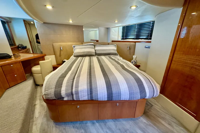 Why Not Yacht Photos Pics Luxurious bedroom interior of 2005 Sunseeker Manhattan 50 yacht with striped bedding.