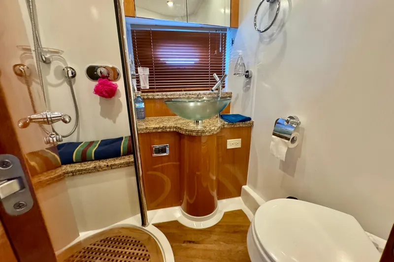 Why Not Yacht Photos Pics Luxurious bathroom in 2005 Sunseeker Manhattan 50 yacht with modern fixtures and wooden accents.
