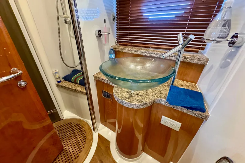 Why Not Yacht Photos Pics Luxurious bathroom in 2005 Sunseeker Manhattan 50 yacht with glass sink and wooden accents.