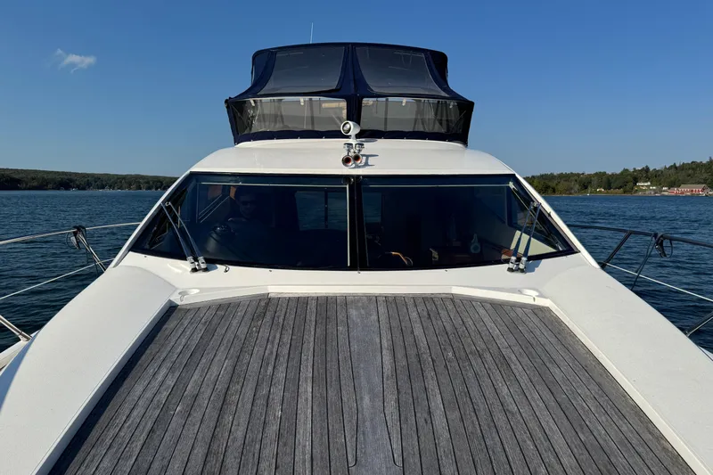 Why Not Yacht Photos Pics 2005 Sunseeker Manhattan 50 yacht on calm water, showcasing sleek design and spacious deck.