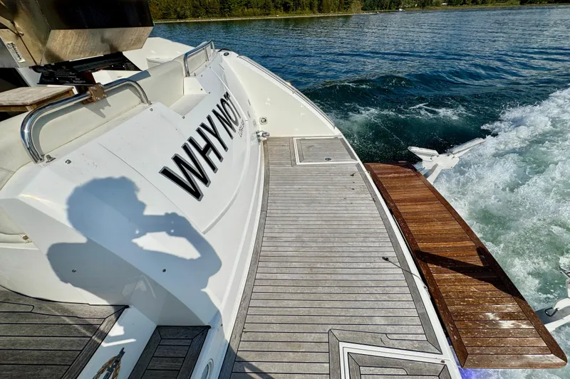 Why Not Yacht Photos Pics 2005 Sunseeker Manhattan 50 yacht with "WHY NOT" name, cruising on water.