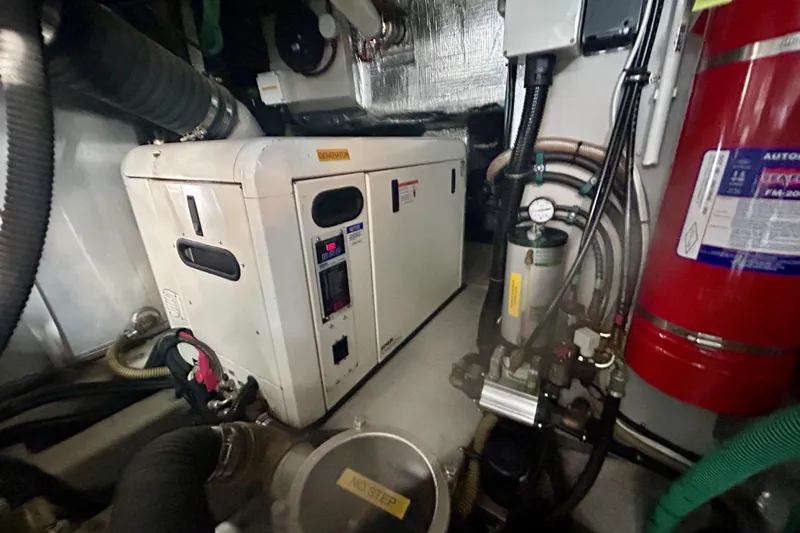 Why Not Yacht Photos Pics Engine room of 2005 Sunseeker Manhattan 50 yacht with generator and fire extinguisher.