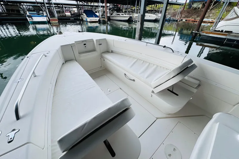  Yacht Photos Pics 2008 Intrepid 327 boat interior with white cushioned seating at a marina.