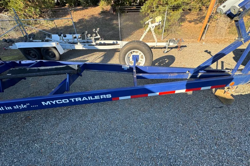  Yacht Photos Pics Blue Myco trailer for 2008 Intrepid 327 boat on gravel lot.