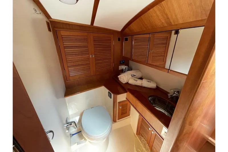 Better By Far Yacht Photos Pics Luxurious 2012 Hinckley Runabout 38 bathroom with wooden cabinetry and modern fixtures.
