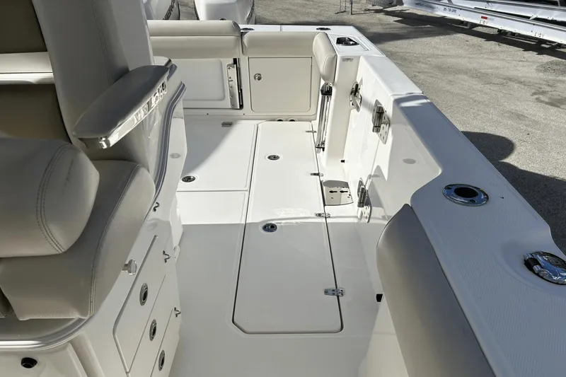  Yacht Photos Pics 2018 Boston Whaler 330 Outrage boat interior with seating and storage compartments.