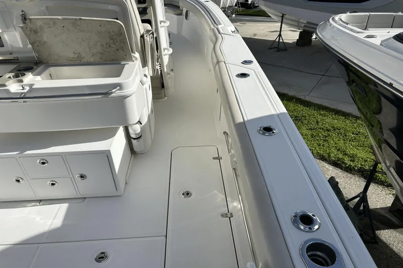  Yacht Photos Pics 2018 Boston Whaler 330 Outrage boat interior with storage compartments and seating area.
