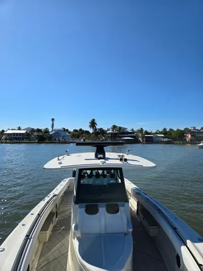  Yacht Photos Pics 2018 HCB 42 Siesta boat on calm water with coastal homes.