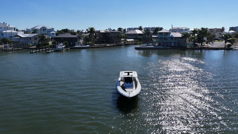  Yacht Photos Pics HCB 42 Siesta 2018 boat on sunny water near coastal homes.