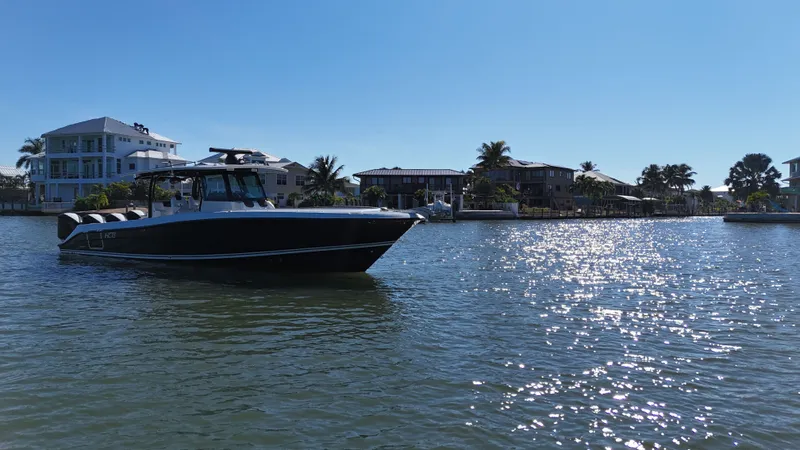  Yacht Photos Pics HCB 42 Siesta 2018 boat on sunny water near coastal homes.