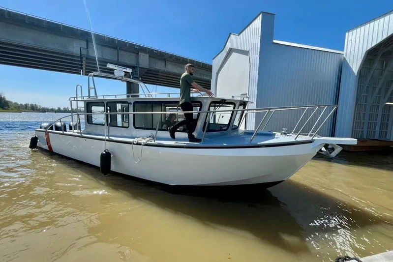  Yacht Photos Pics Custom 1990 rebuilt dive boat offshore, docked under a bridge on a sunny day.