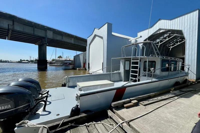  Yacht Photos Pics Custom 1990 rebuilt dive boat docked near a bridge, featuring Yamaha engines.
