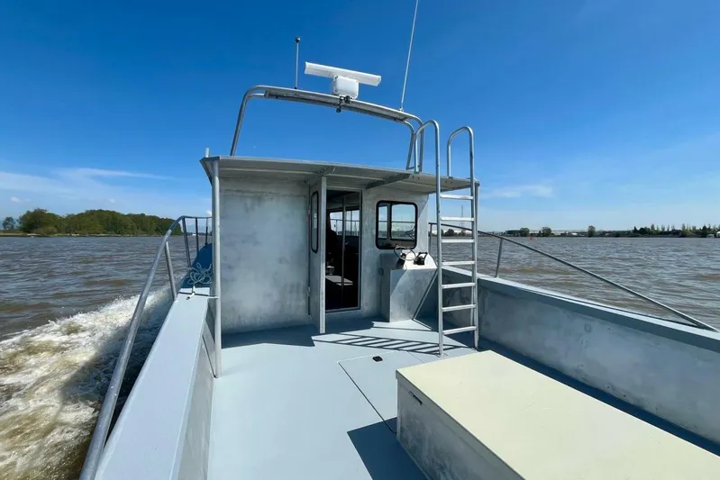  Yacht Photos Pics Custom 1990 rebuilt dive boat offshore, cruising on a sunny day with clear skies.