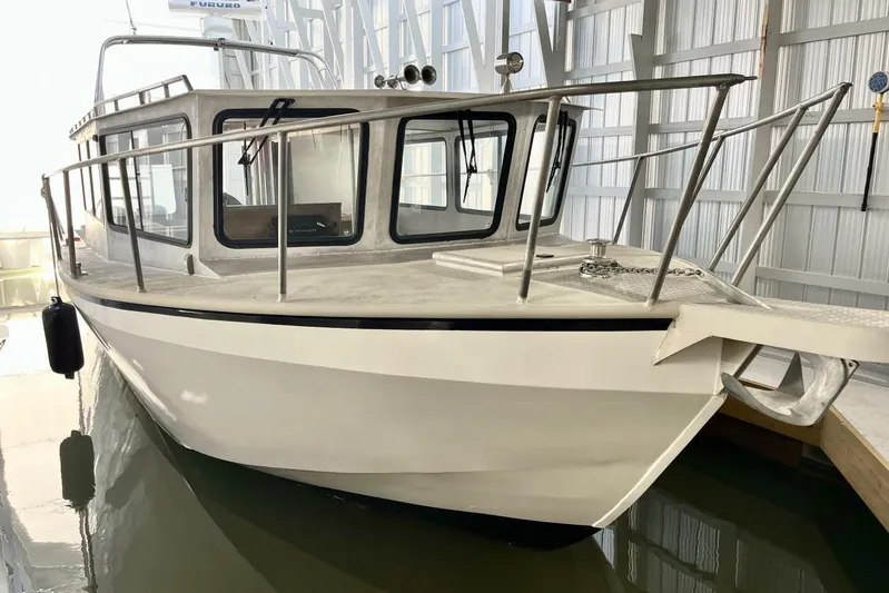  Yacht Photos Pics Custom 1990 rebuilt dive boat/offshore vessel in a marina setting.