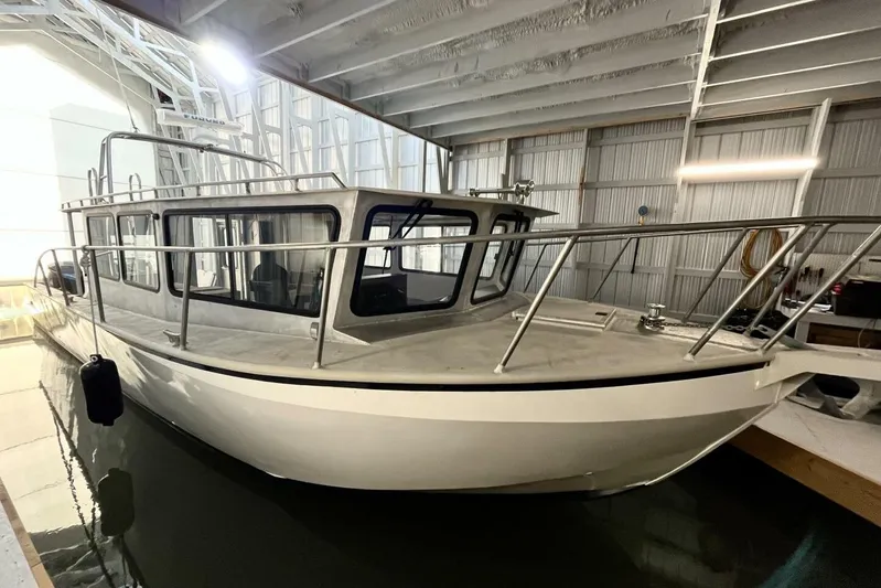  Yacht Photos Pics Custom 1990 rebuilt dive boat/offshore vessel in a covered dock.